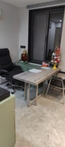"Modern psychiatrist's clinic with a desk and comfortable chairs, showing a welcoming environment for consultations."