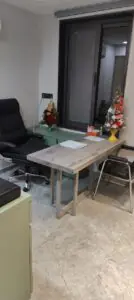 "Modern psychiatrist's clinic with a desk and comfortable chairs, showing a welcoming environment for consultations."