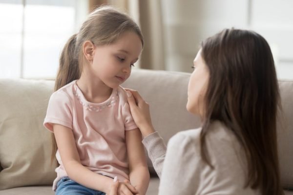 Child receiving emotional support for childhood obsessive compulsive disorder from psychiatrist in Indore