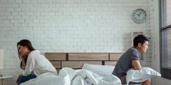 Couples Conflict Resolution and Counseling by Dr. Varchasvi Mudgal – Psychiatrist in Indore Couple arguing in bed, a scenario that may benefit from relationship counseling and psychiatric support by Dr. Varchasvi Mudgal in Indore.