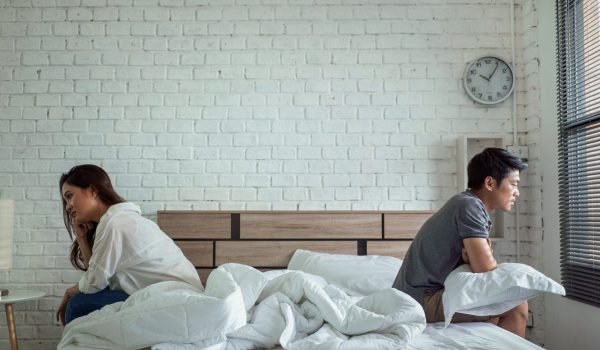 Couple arguing in bed, a scenario that may benefit from relationship counseling and psychiatric support by Dr. Varchasvi Mudgal in Indore.